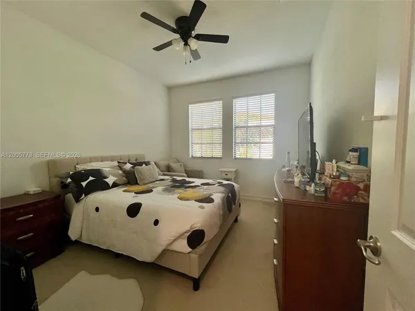 a bedroom with a bed and a mirror