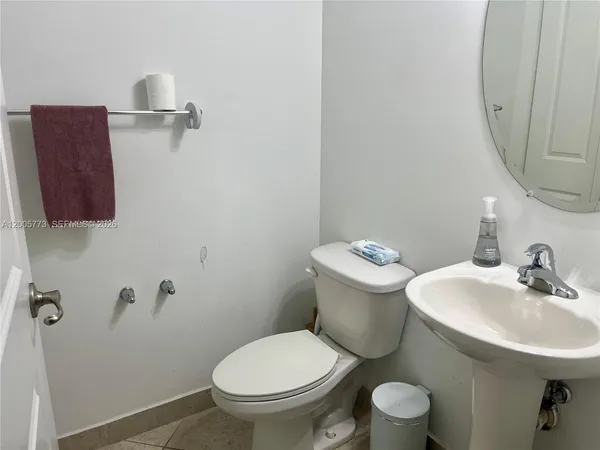 a bathroom with a toilet sink and mirror