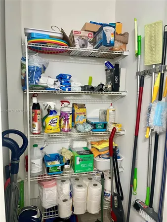 a room with lots of clutter and cabinets