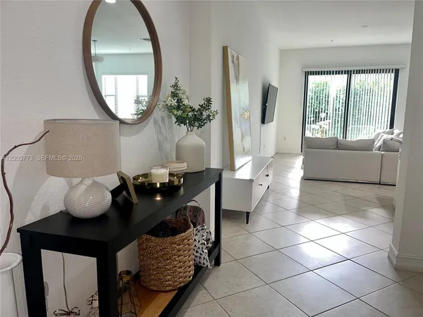 a living room with furniture and a mirror