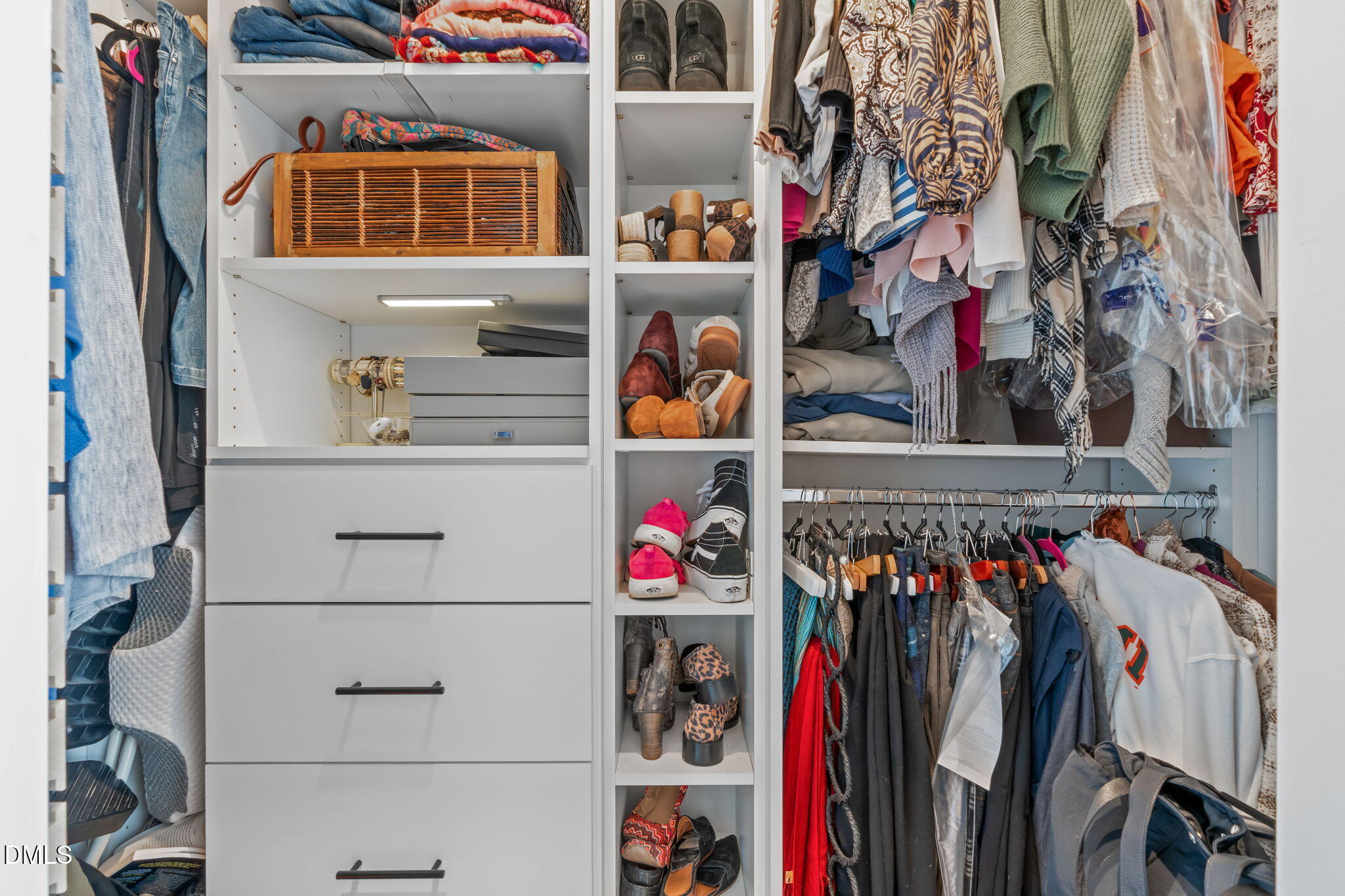319 Fayetteville Street, Unit 410 Raleigh, NC 27601 - Photo 21 of 28 a view of walk in closet with clothes and shoes