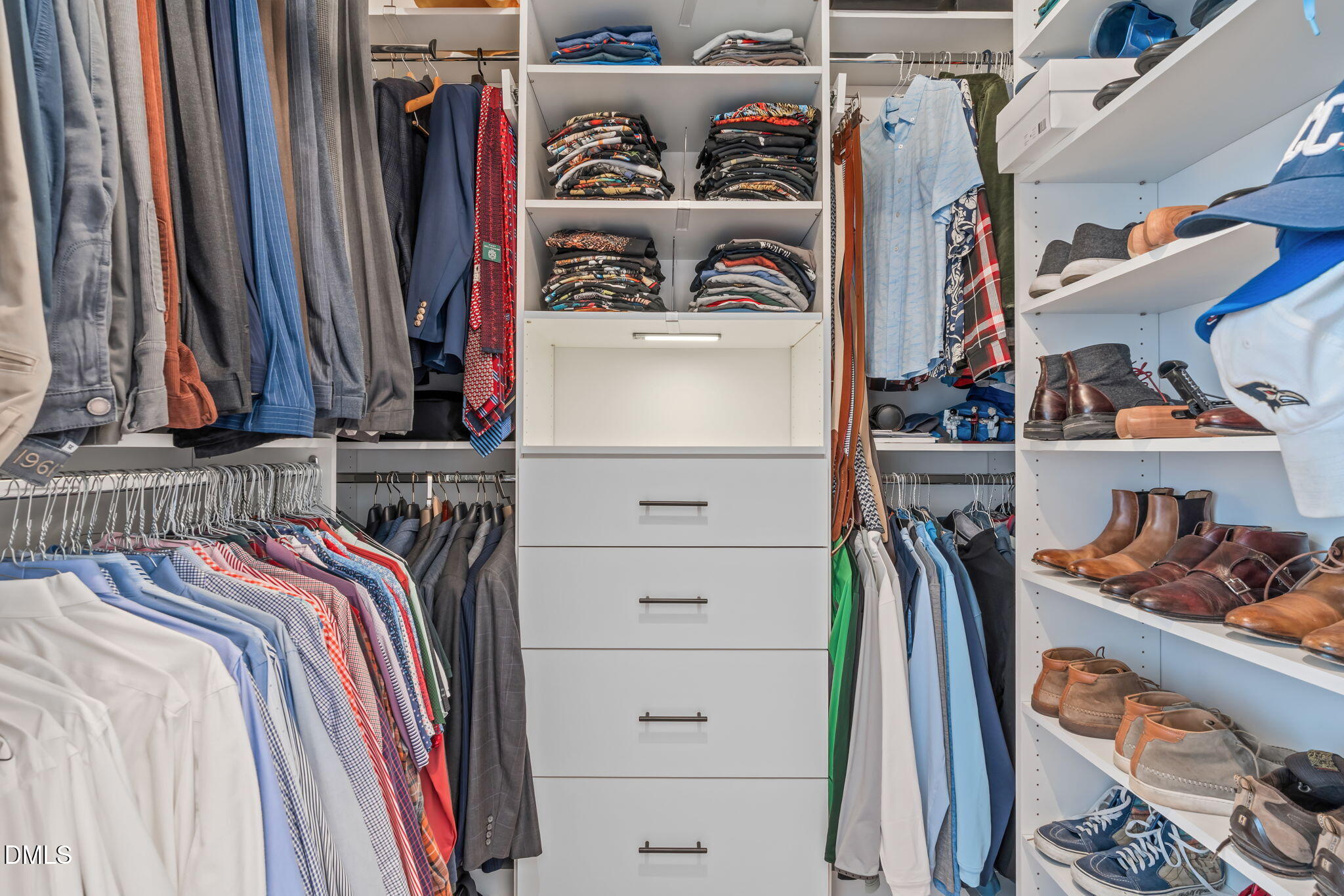 319 Fayetteville Street, Unit 410 Raleigh, NC 27601 - Photo 22 of 28 a view of walk in closet with clothes and shoes