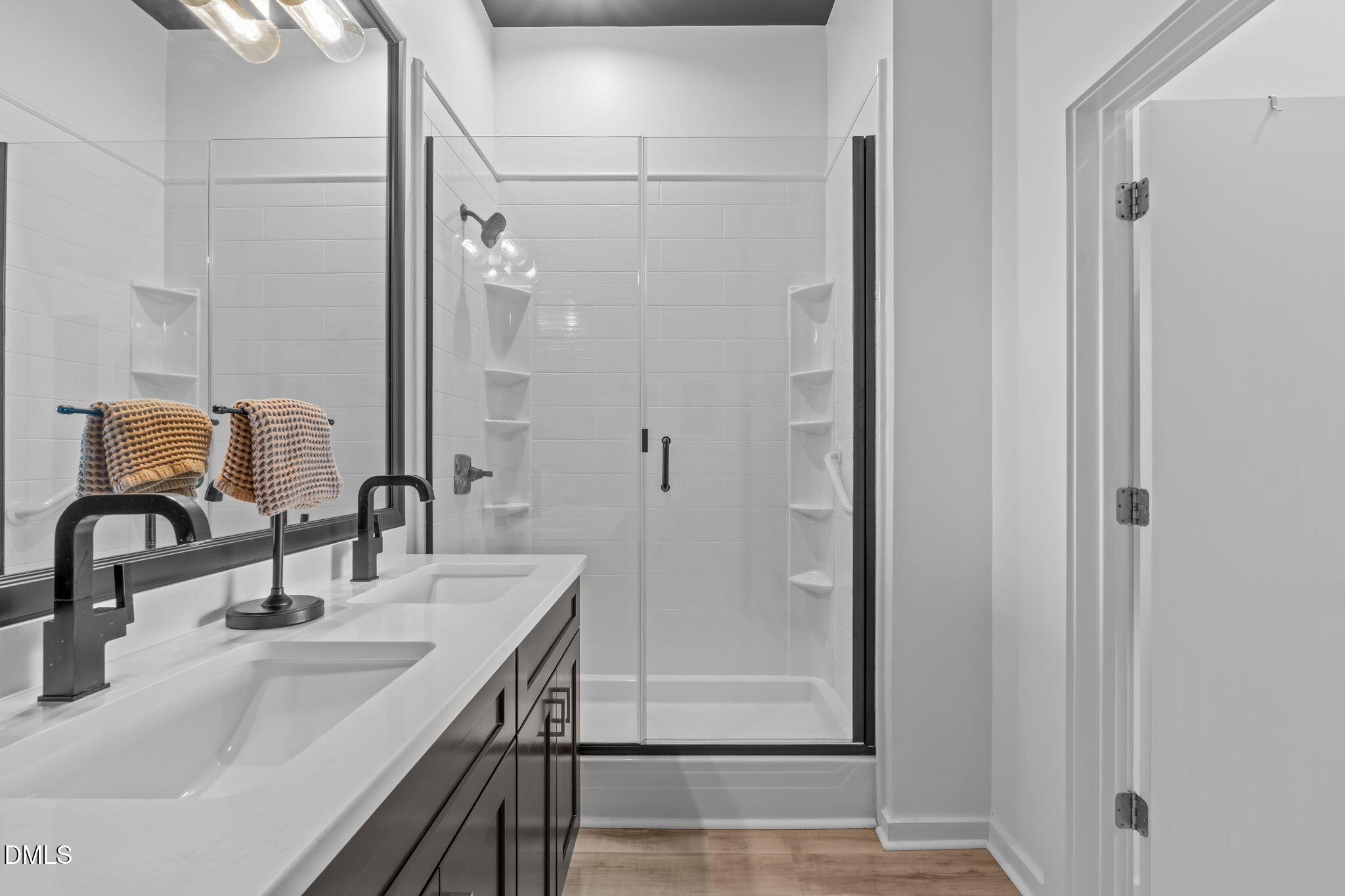 319 Fayetteville Street, Unit 410 Raleigh, NC 27601 - Photo 24 of 28 a bathroom with double vanity sink and a mirror