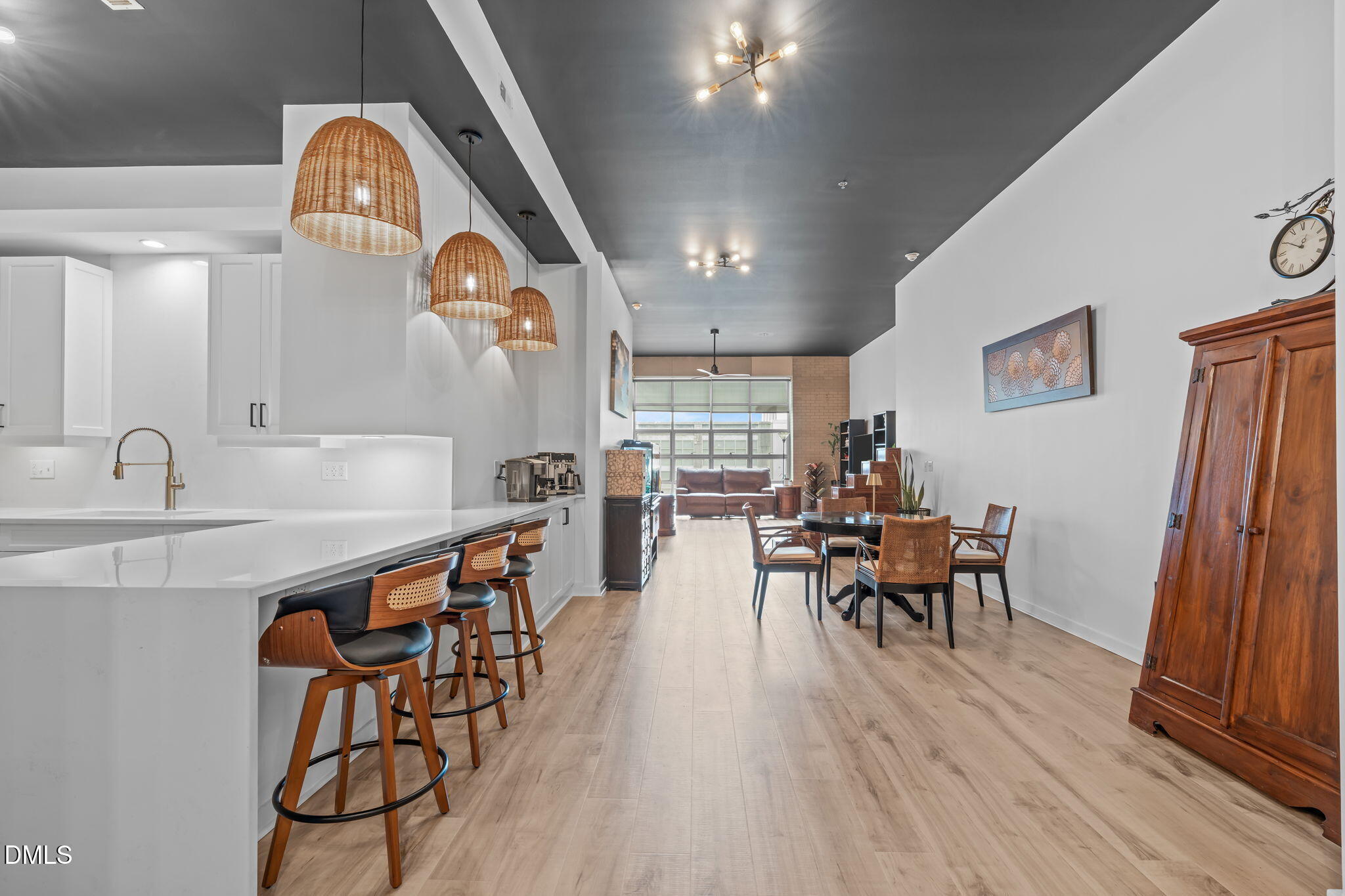 319 Fayetteville Street, Unit 410 Raleigh, NC 27601 - Photo 3 of 28 a view of a dining room with furniture and wooden floor