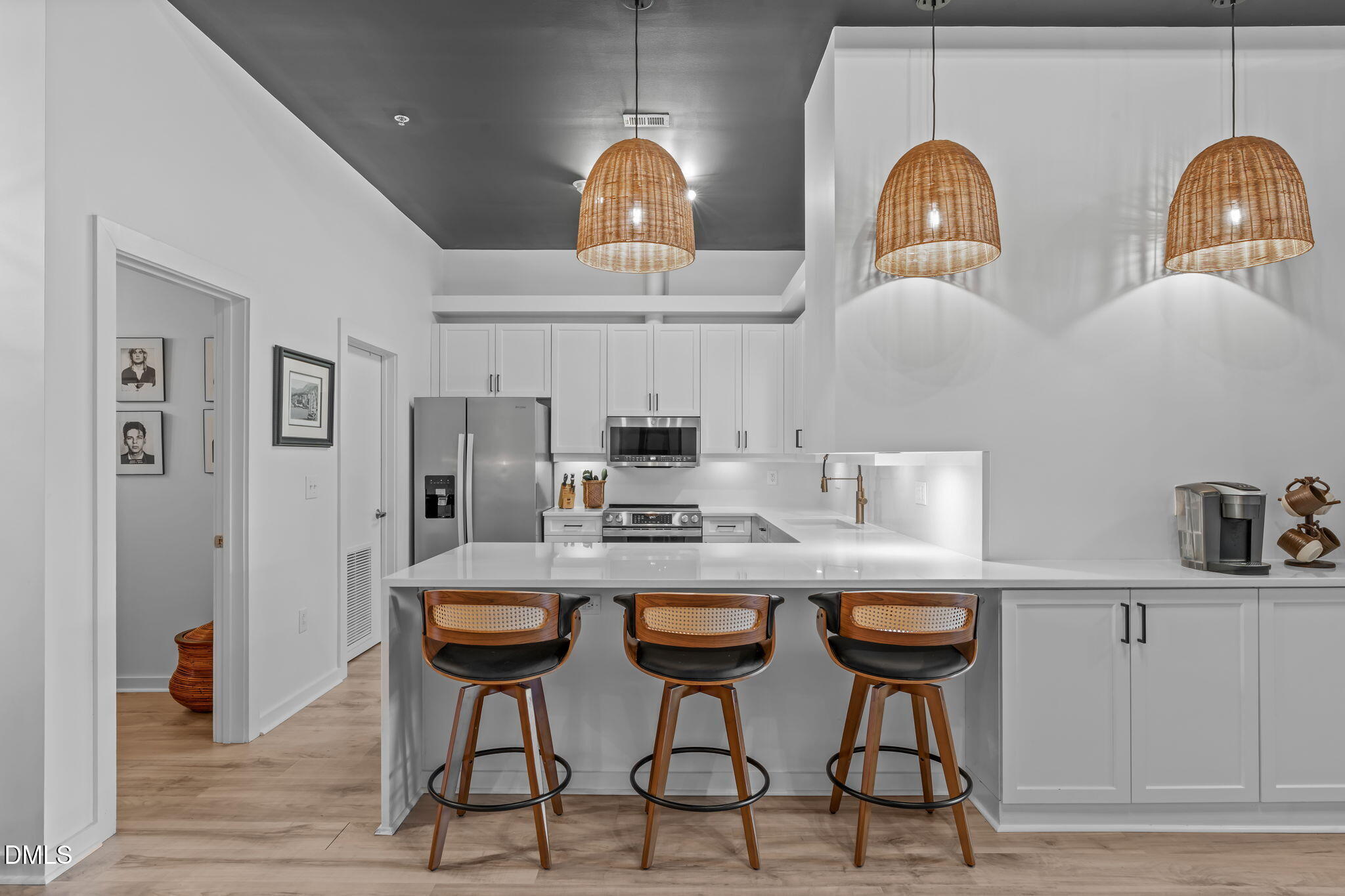 319 Fayetteville Street, Unit 410 Raleigh, NC 27601 - Photo 4 of 28 a kitchen with stainless steel appliances a dining table and chairs