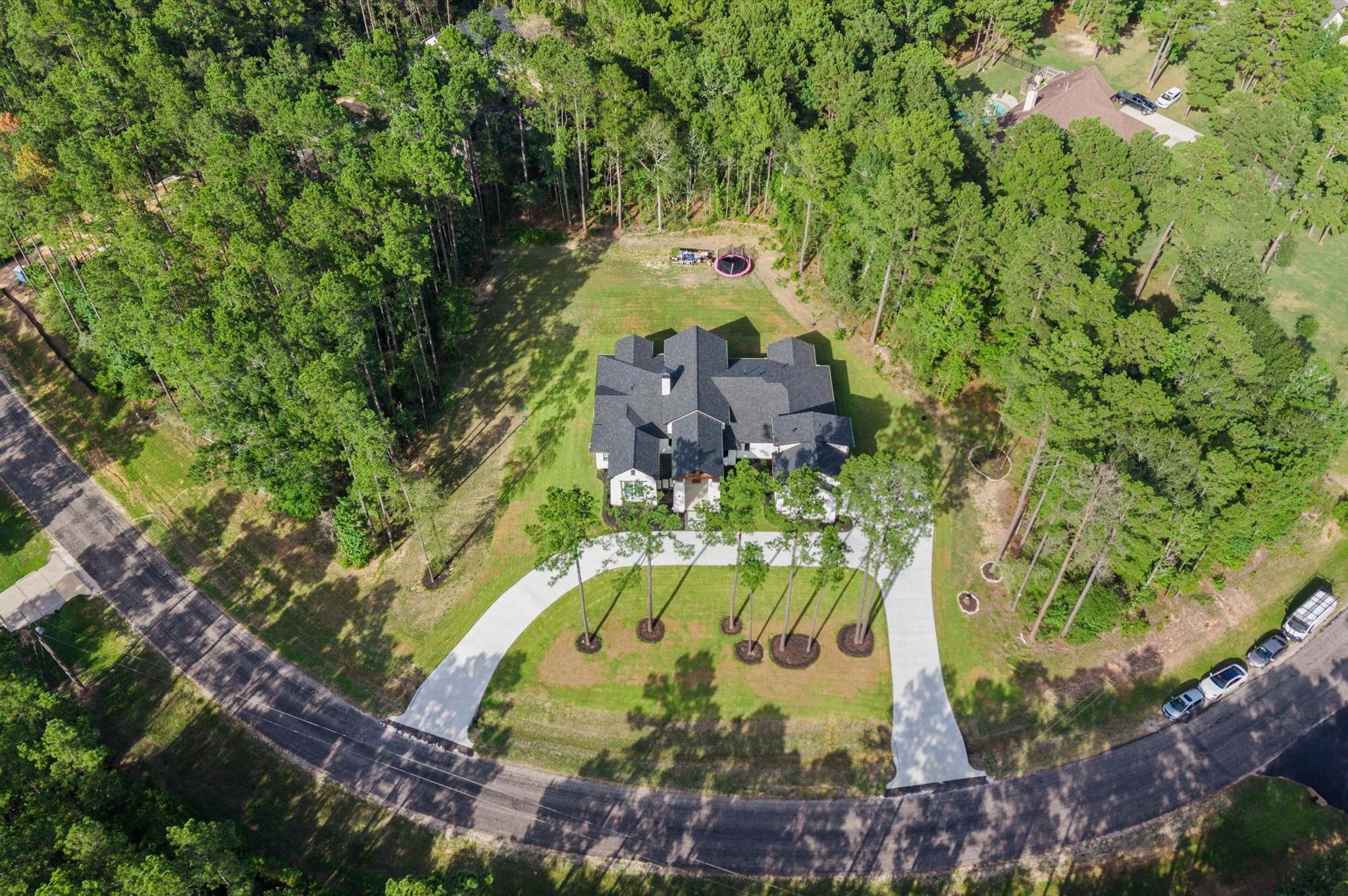 437 Sundog Road Huntsville, TX 77340 - Photo 2 of 50 One-of-a-kind custom home situated on a private 2-acre corner lot in Texas Grand Ranch, surrounded by mature trees and designed with timeless architectural details.