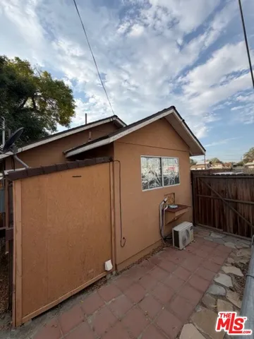 a backyard of a house with table and chairs