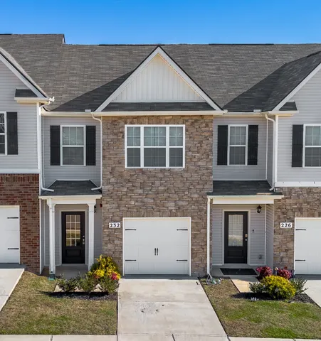 a front view of a house with yard