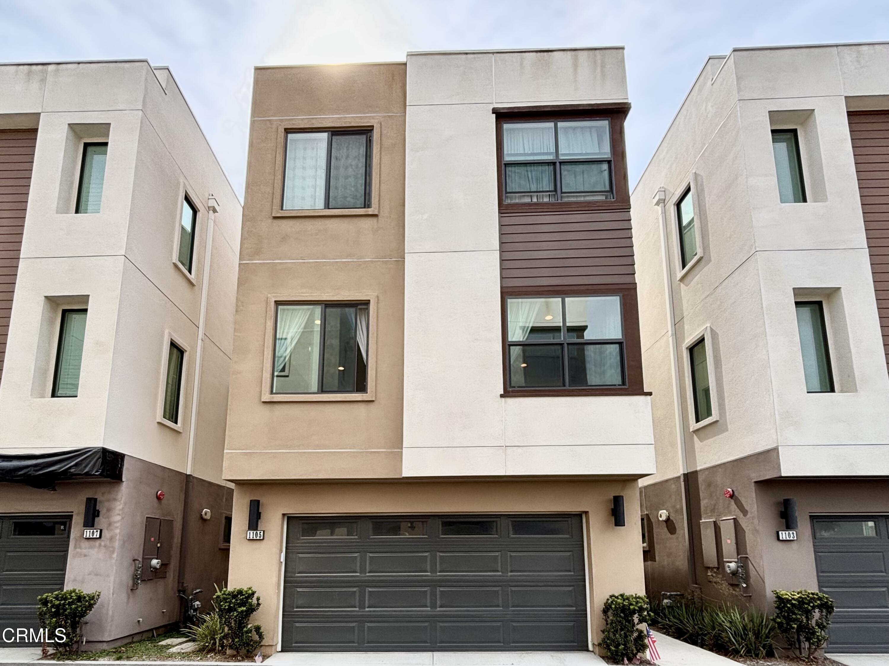 a front view of a house with many windows