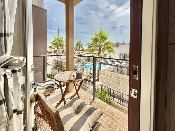 a balcony with table and chairs