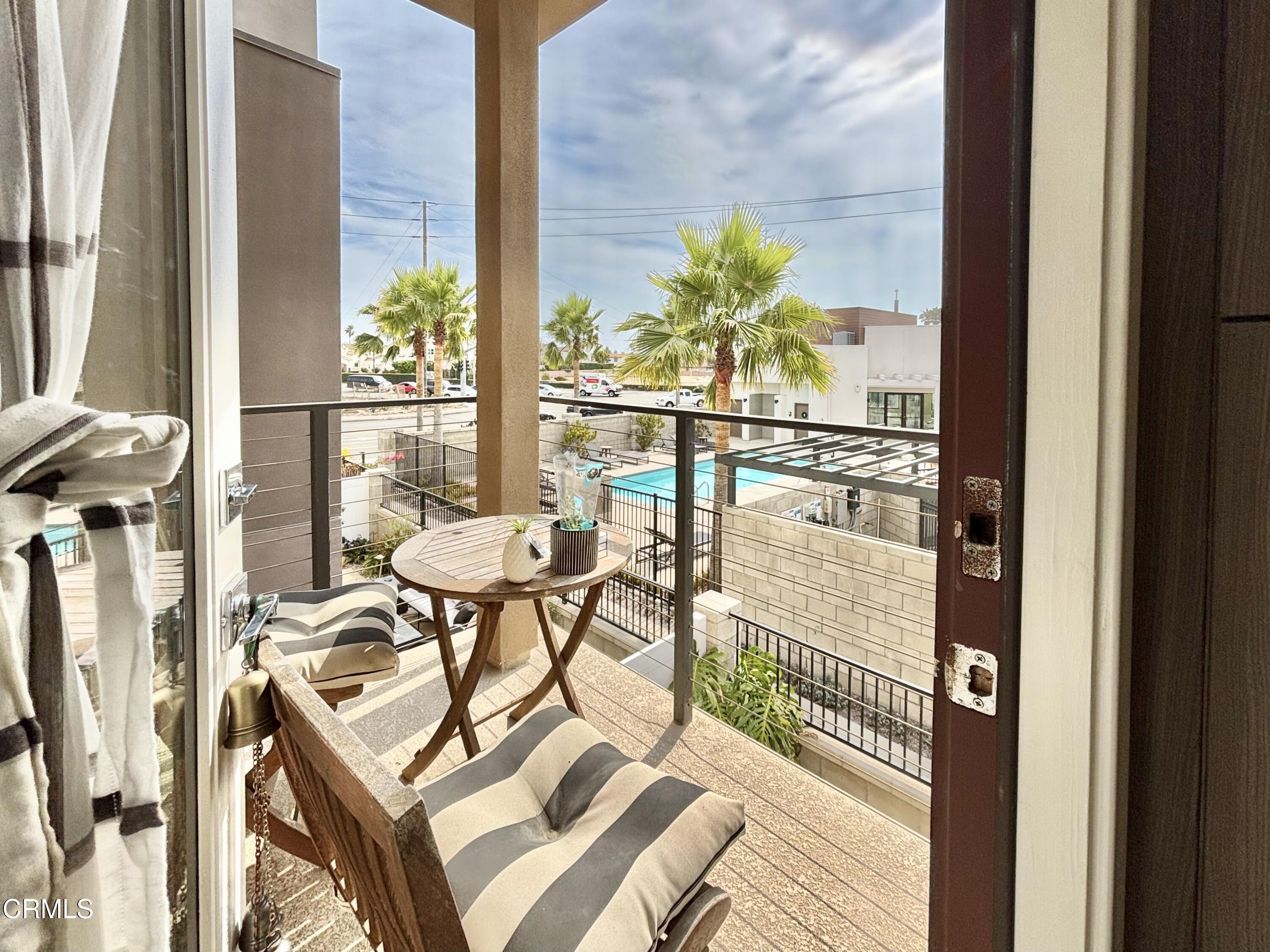 1105 Canal Street Oxnard, CA 93035 - Photo 3 of 14 a balcony with table and chairs