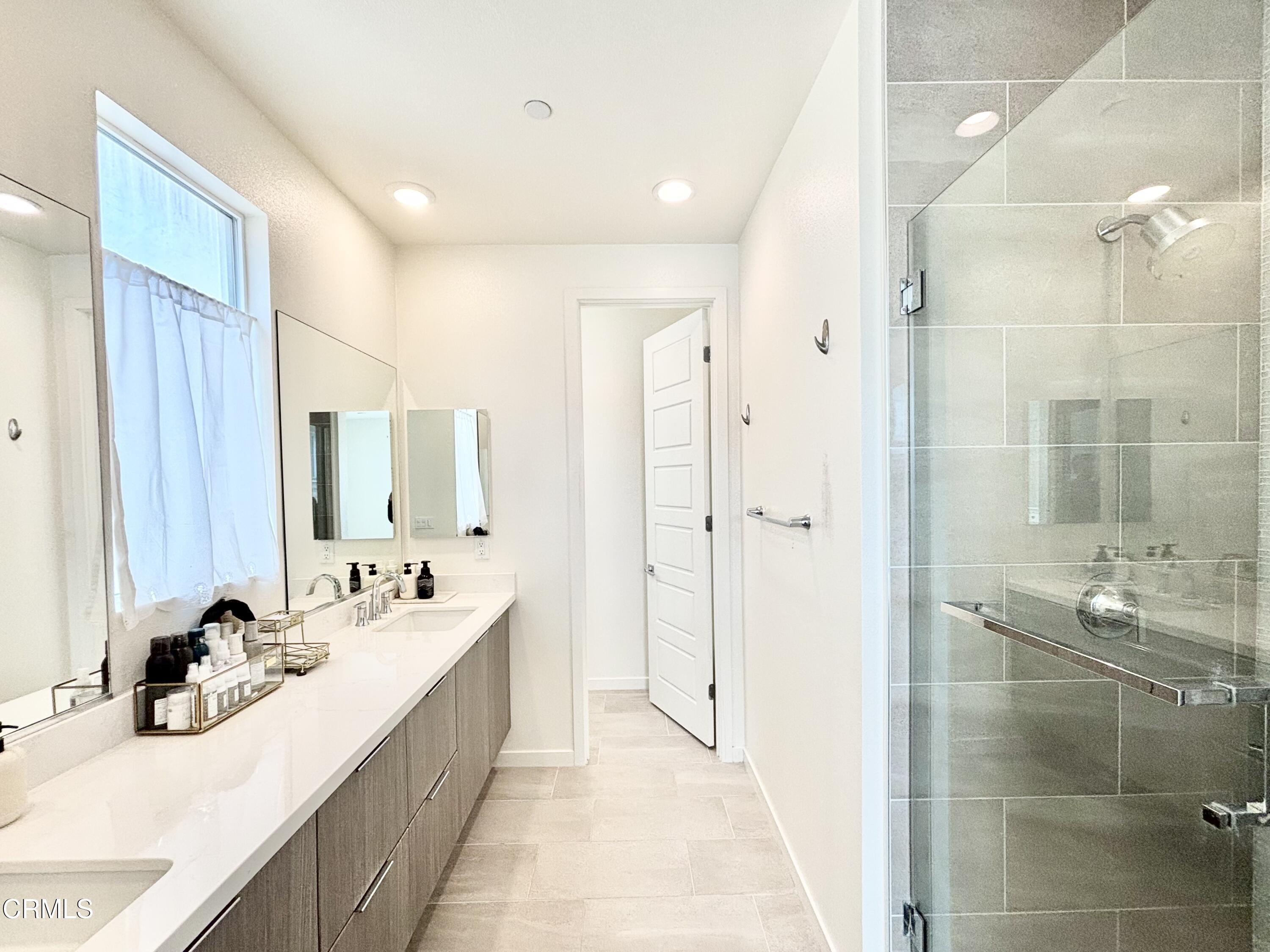 1105 Canal Street Oxnard, CA 93035 - Photo 4 of 14 a bathroom with a double vanity sink mirror and shower
