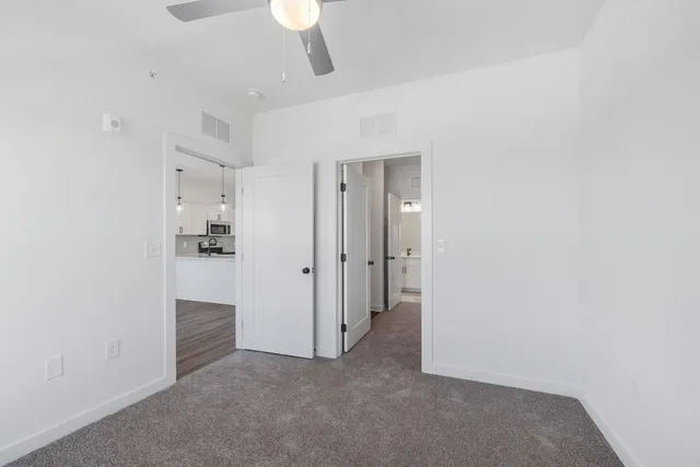 a bathroom with a double vanity sink toilet mirror and shower