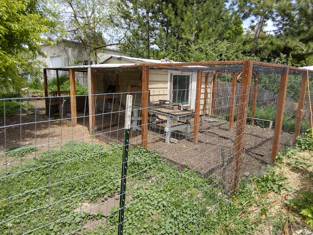157 West 500 South Logan, UT 84321 - Photo 14 of 38 Enclosed outdoor structure featuring a shingled exterior, a secure window, and a perimeter fence with wood posts