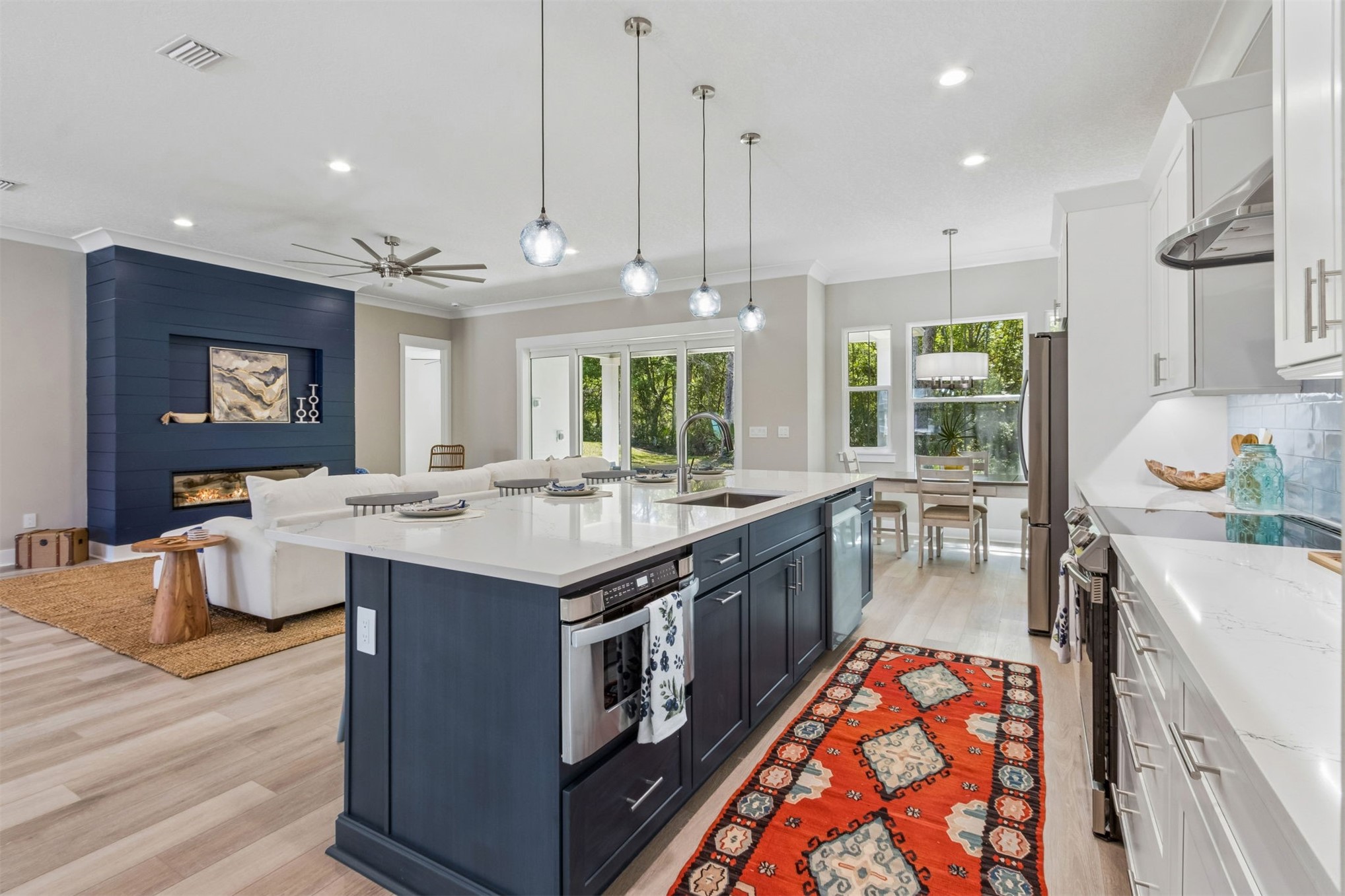 96050 Captains Pointe Road Yulee, FL 32097 - Photo 14 of 36 a kitchen with stainless steel appliances granite countertop a sink a stove and a wooden floors