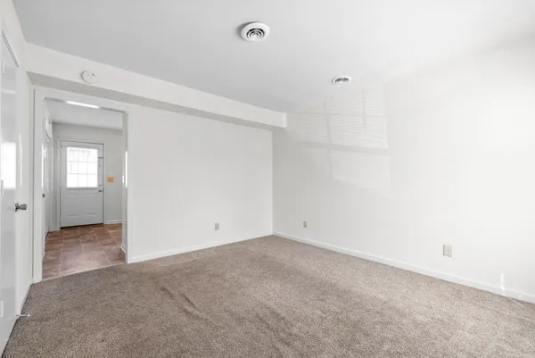 an empty room with closet and bathroom