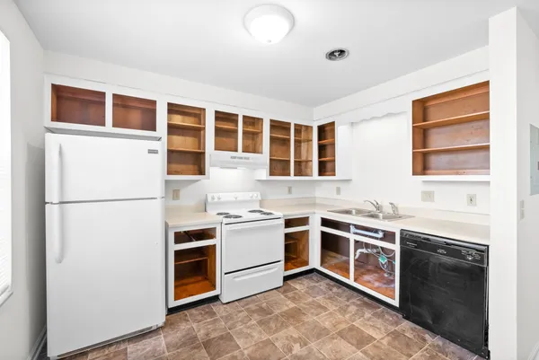 a kitchen with stainless steel appliances granite countertop a stove sink and refrigerator