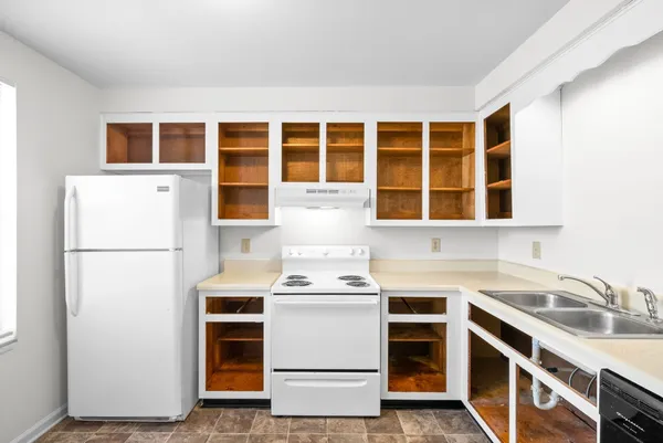 a kitchen with a stove and a refrigerator