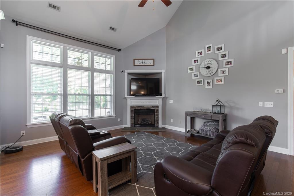 313 Miners Cove Way Fort Mill, SC 29708 - Photo 12 of 38 a living room with furniture a fireplace and a large window