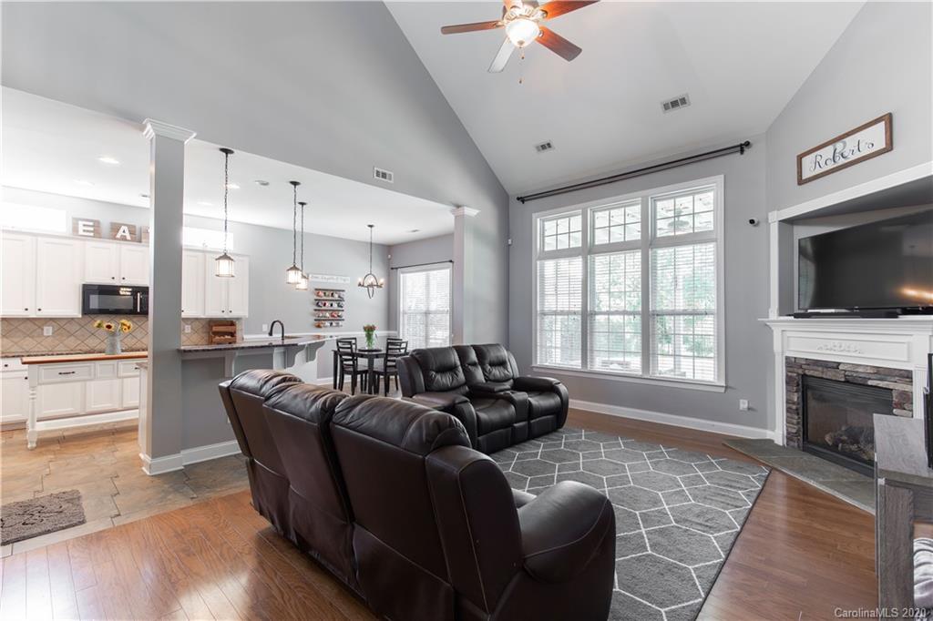 313 Miners Cove Way Fort Mill, SC 29708 - Photo 13 of 38 a living room with furniture flat screen tv and a fireplace