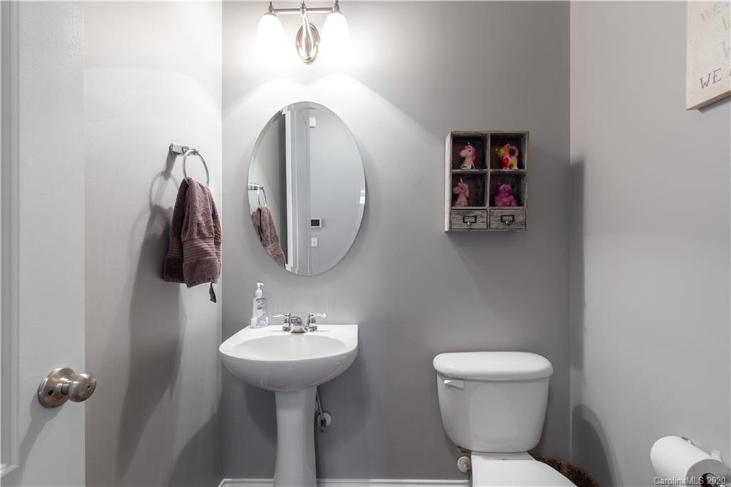 313 Miners Cove Way Fort Mill, SC 29708 - Photo 14 of 38 a bathroom with a toilet sink and mirror