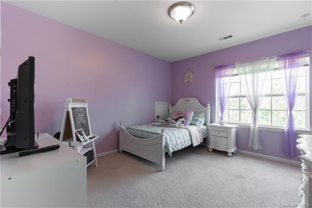 313 Miners Cove Way Fort Mill, SC 29708 - Photo 21 of 38 a bed room with a bed and a chair