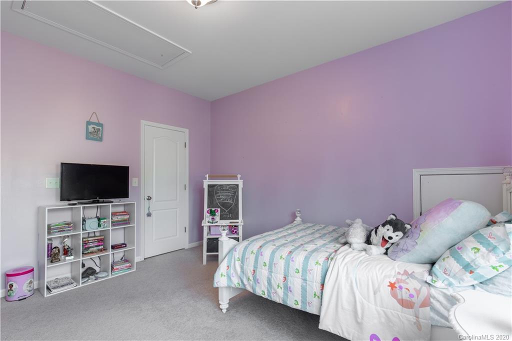 313 Miners Cove Way Fort Mill, SC 29708 - Photo 22 of 38 a bedroom with a bed and a flat screen tv