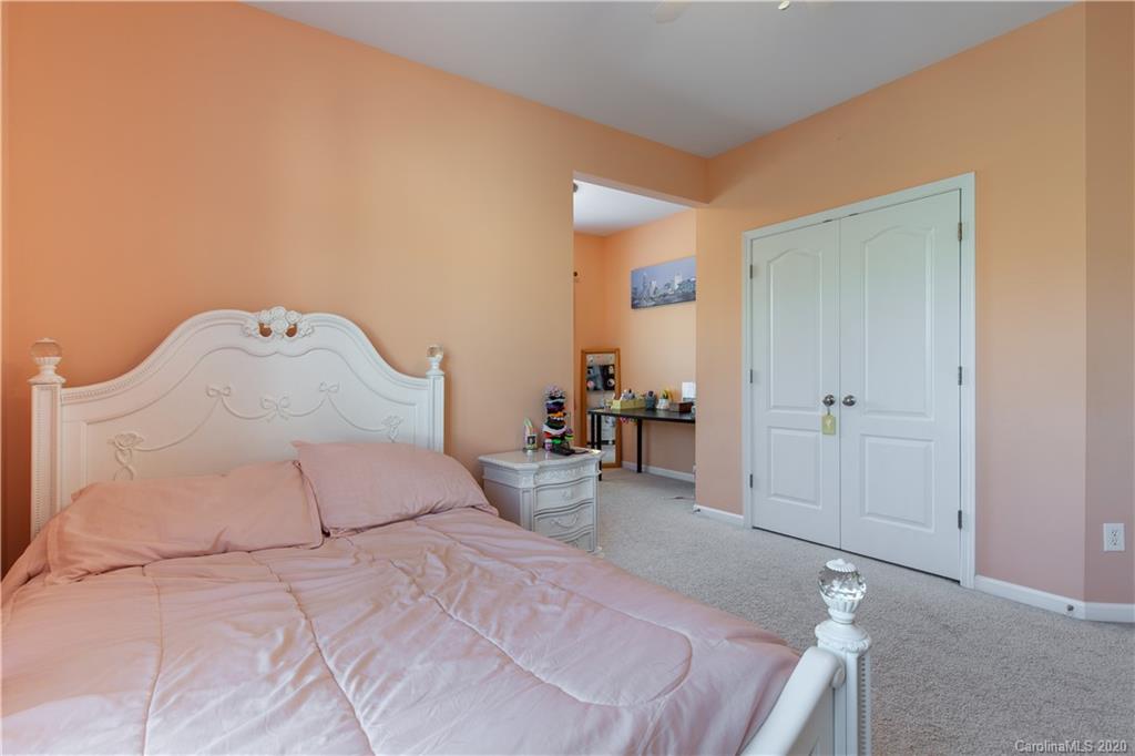 313 Miners Cove Way Fort Mill, SC 29708 - Photo 24 of 38 a bedroom with a bed and a potted plant