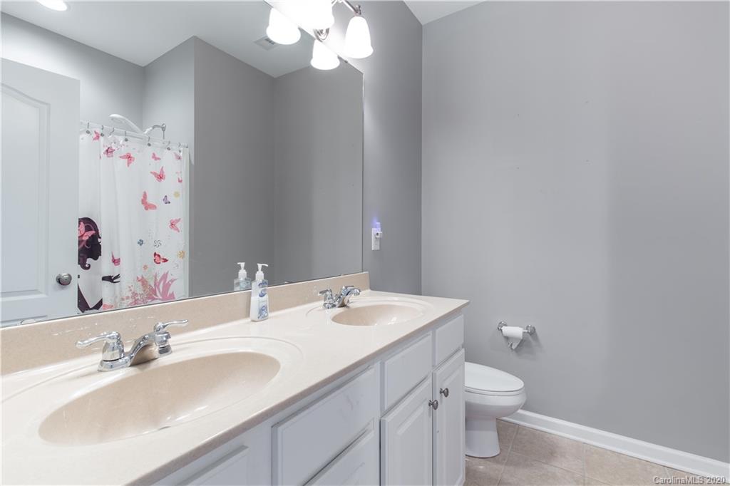 313 Miners Cove Way Fort Mill, SC 29708 - Photo 25 of 38 a bathroom with a sink vanity granite and toilet