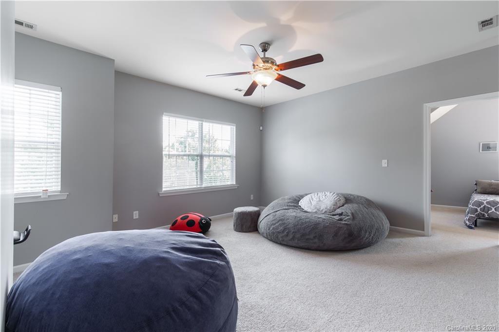313 Miners Cove Way Fort Mill, SC 29708 - Photo 26 of 38 a bedroom with a bed and a chandelier