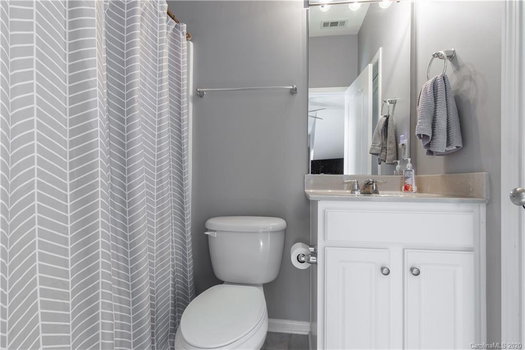 313 Miners Cove Way Fort Mill, SC 29708 - Photo 29 of 38 a bathroom with a toilet sink and mirror