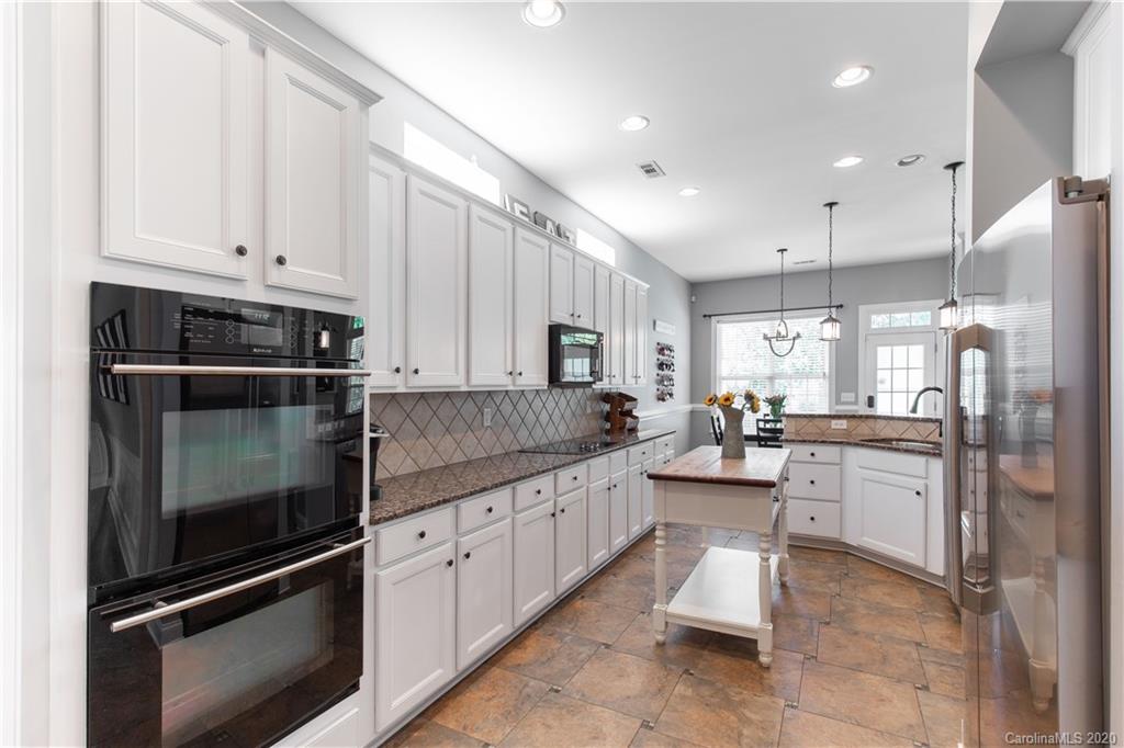 313 Miners Cove Way Fort Mill, SC 29708 - Photo 8 of 38 a kitchen with counter top space cabinets and stainless steel appliances