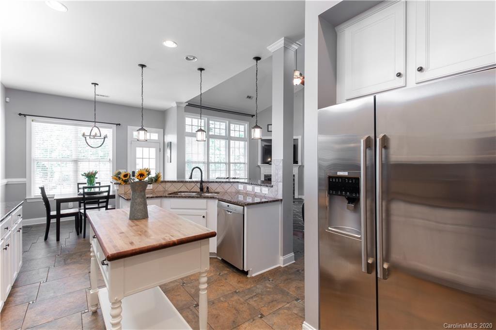 313 Miners Cove Way Fort Mill, SC 29708 - Photo 9 of 38 a kitchen with a sink refrigerator and cabinets