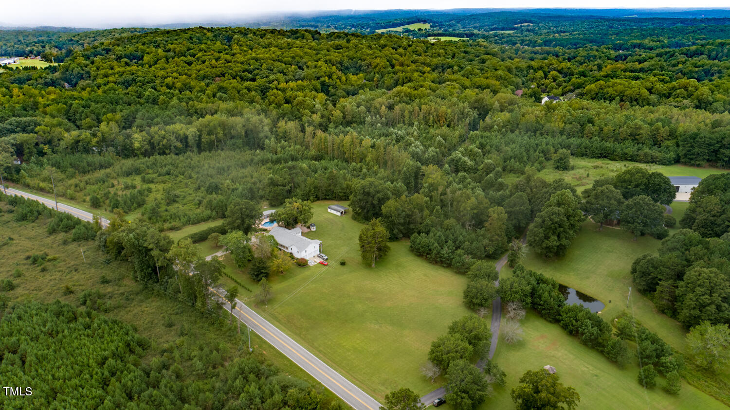 9841 Quail Roost Road Bahama, NC 27503 - Photo 4 of 12 a view of a forest with a lake
