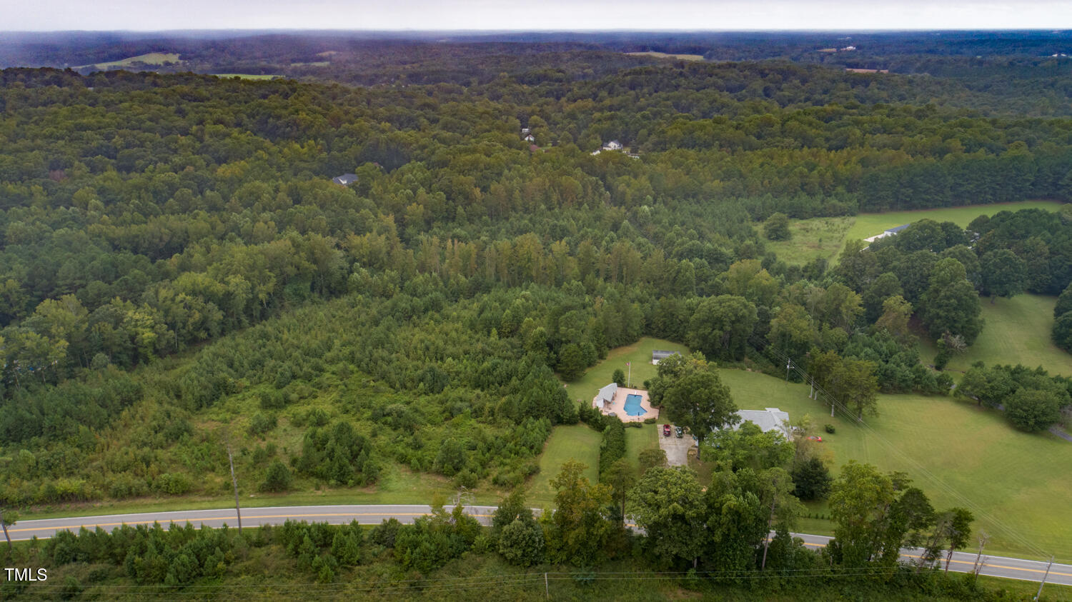 9841 Quail Roost Road Bahama, NC 27503 - Photo 5 of 12 an aerial view of green landscape with trees and houses