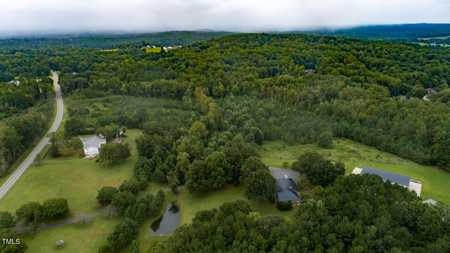 9841 Quail Roost Road Bahama, NC 27503 - Photo 7 of 12 an aerial view of residential houses with outdoor space and trees