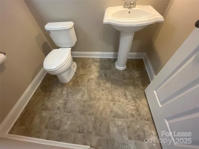 a bathroom with a sink toilet and a mirror