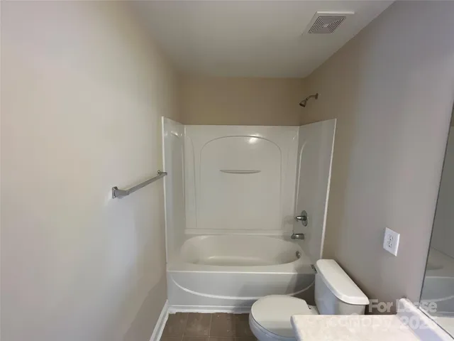 a bathroom with a toilet a sink and bathtub