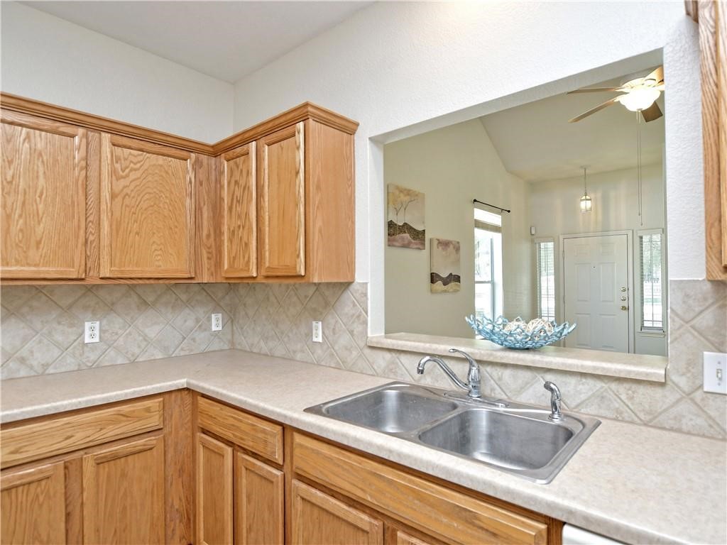 1117 Rawhide Trail Cedar Park, TX 78613 - Photo 12 of 36 a kitchen with granite countertop a sink and cabinets