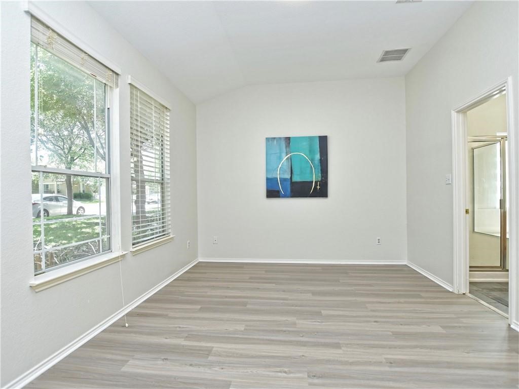 1117 Rawhide Trail Cedar Park, TX 78613 - Photo 17 of 36 a view of an empty room with wooden floor and a window