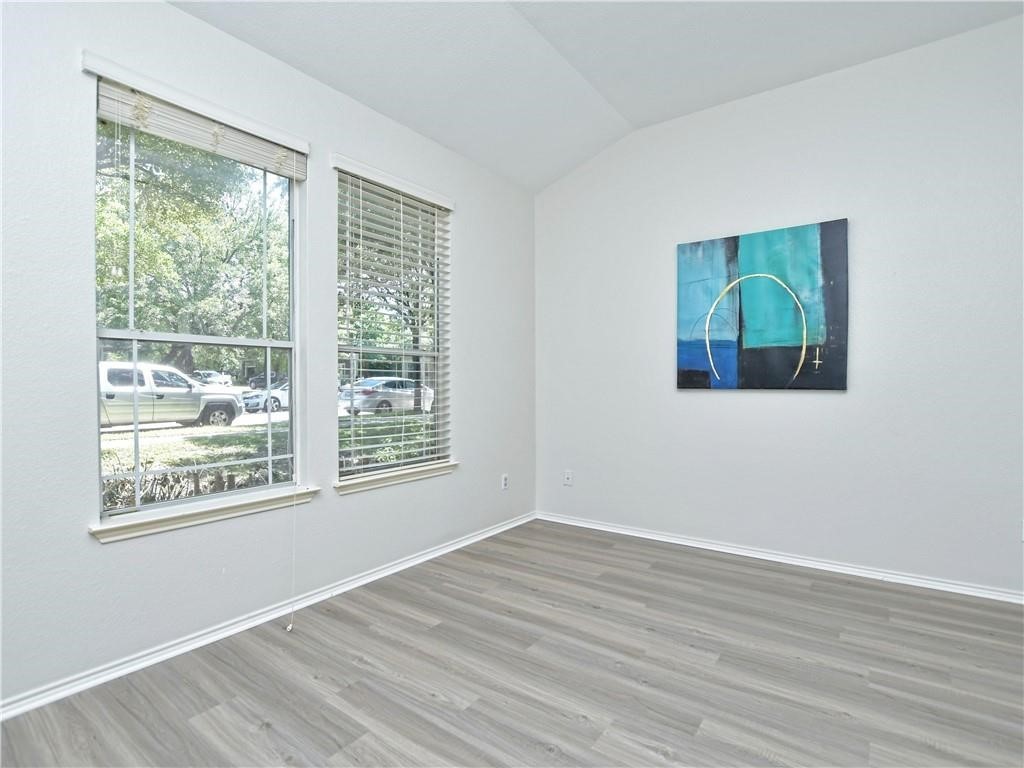 1117 Rawhide Trail Cedar Park, TX 78613 - Photo 18 of 36 a view of an empty room with wooden floor and a window
