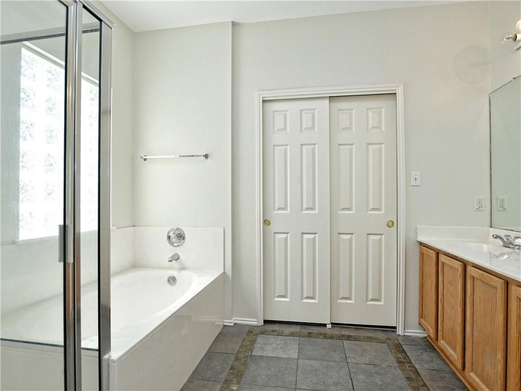 1117 Rawhide Trail Cedar Park, TX 78613 - Photo 19 of 36 a view of bathroom with bathtub shower and mirror