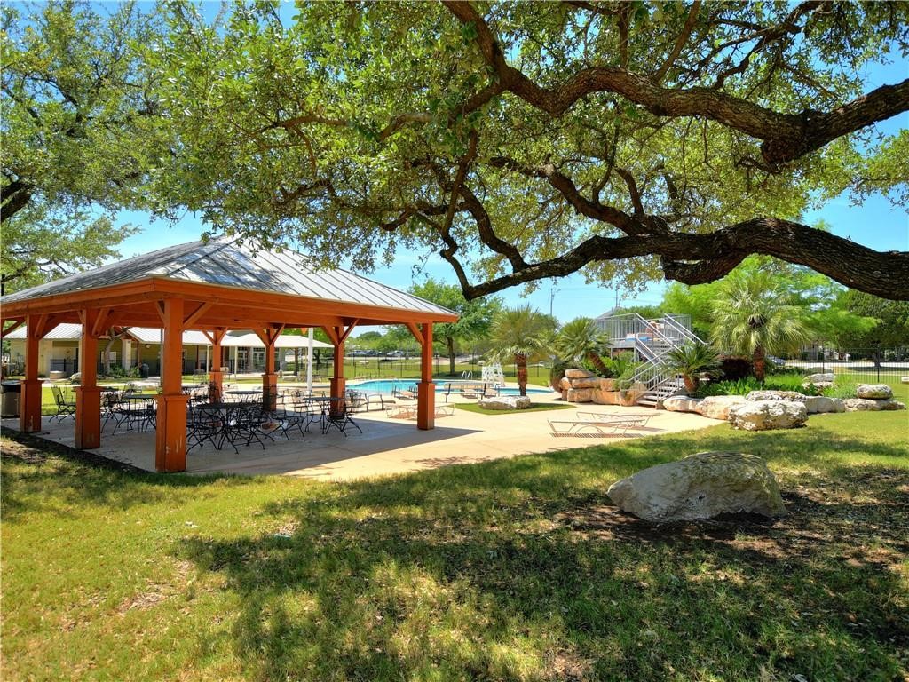 1117 Rawhide Trail Cedar Park, TX 78613 - Photo 33 of 36 a view of a swimming pool with lawn chairs under an umbrella