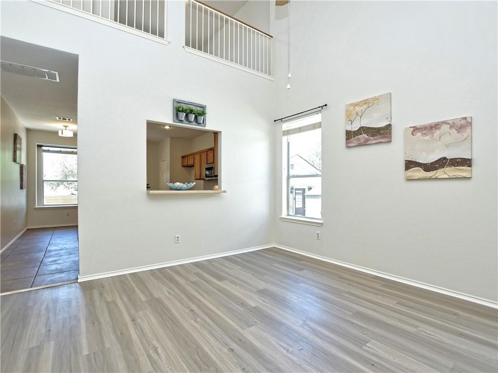1117 Rawhide Trail Cedar Park, TX 78613 - Photo 6 of 36 an empty room with wooden floor and windows