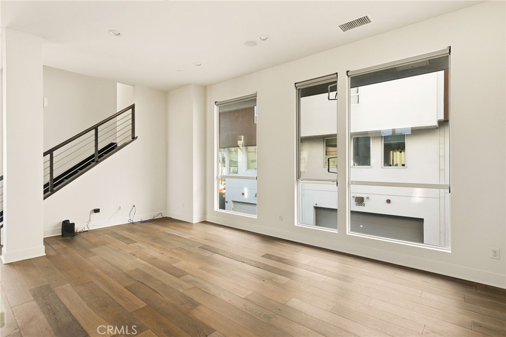 2201 Tom Mix Road Silver Lake, CA 90026 - Photo 9 of 25 a view of an empty room with wooden floor and a window