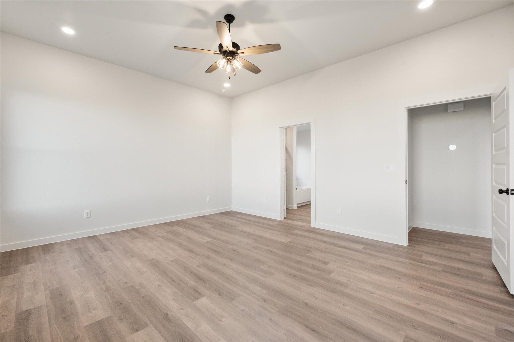 7006 56th Street Lubbock, TX 79407 - Photo 12 of 22 a view of an empty room with wooden floor
