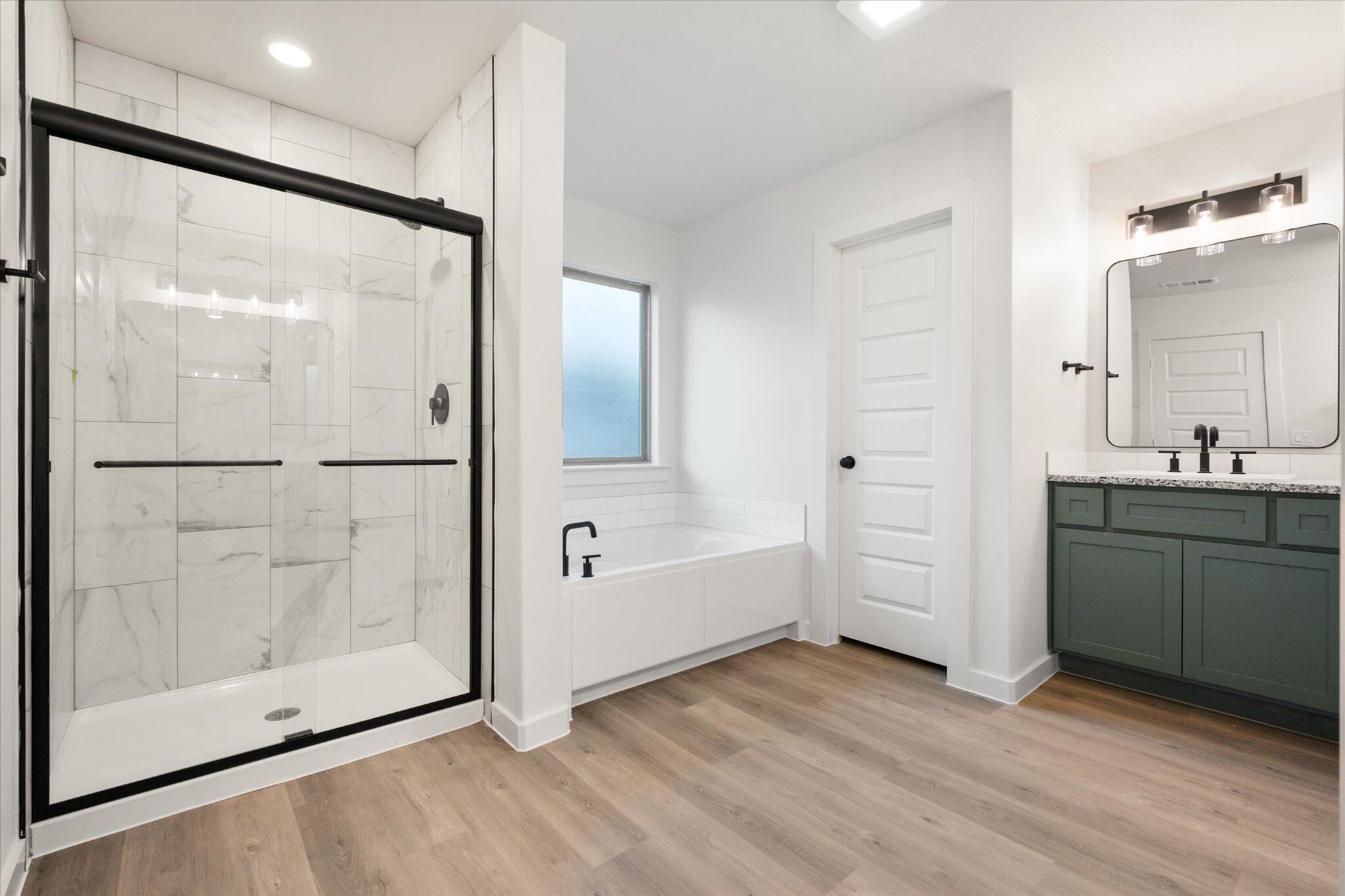 7006 56th Street Lubbock, TX 79407 - Photo 14 of 22 a view of bathroom with a tub shower and sink