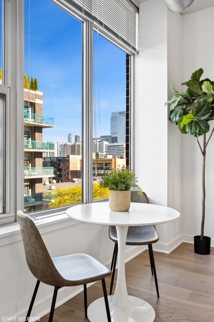 901 West Madison Street, Unit 615 Chicago, IL 60607 - Photo 5 of 25 a view of a dining room with furniture window and wooden floor