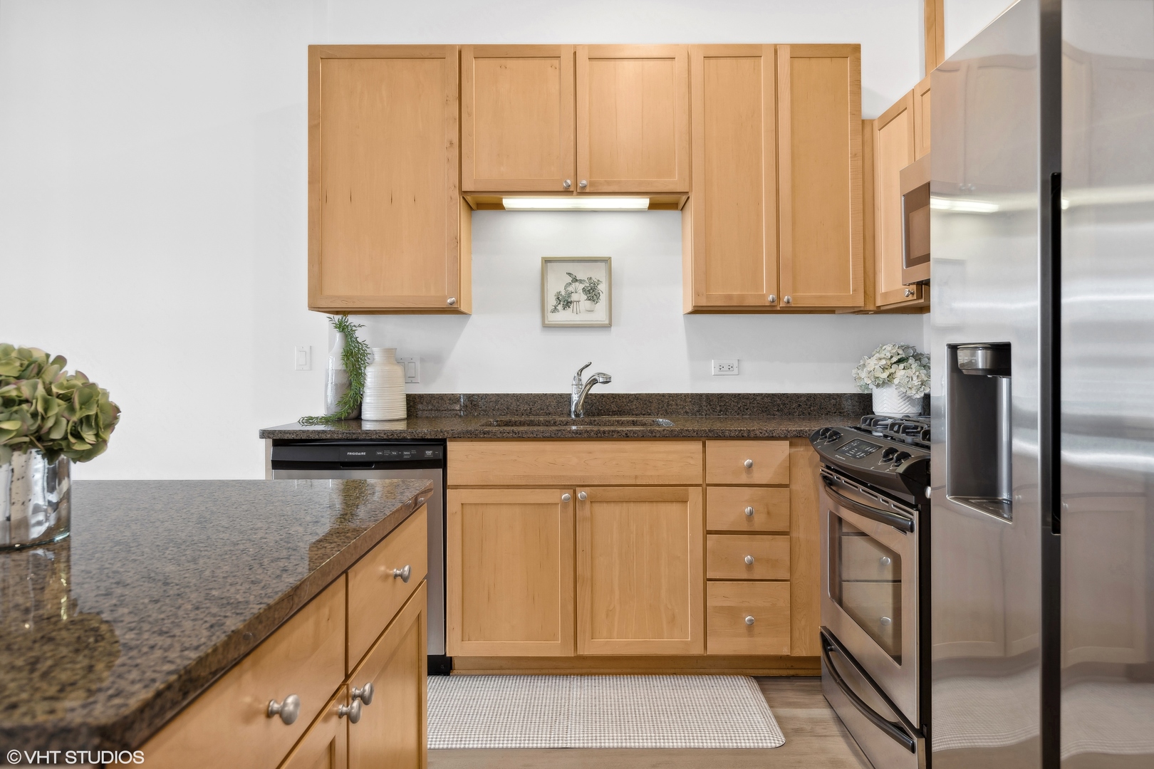 901 West Madison Street, Unit 615 Chicago, IL 60607 - Photo 10 of 25 a kitchen with stainless steel appliances granite countertop a sink a stove and a refrigerator