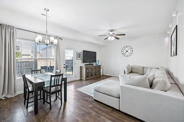 a living room with furniture a table and a flat screen tv